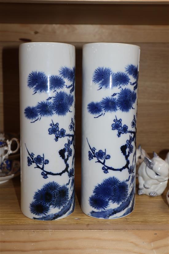 A pair of Chinese blue and white oval section sleeve vases height 25cm (one a.f.)